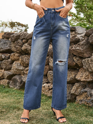 Distressed flare denim jeans in navy with ripped details and a buttoned fly.