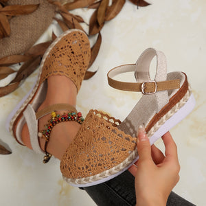 Brown crochet espadrille sandals with ankle strap and buckle detail.