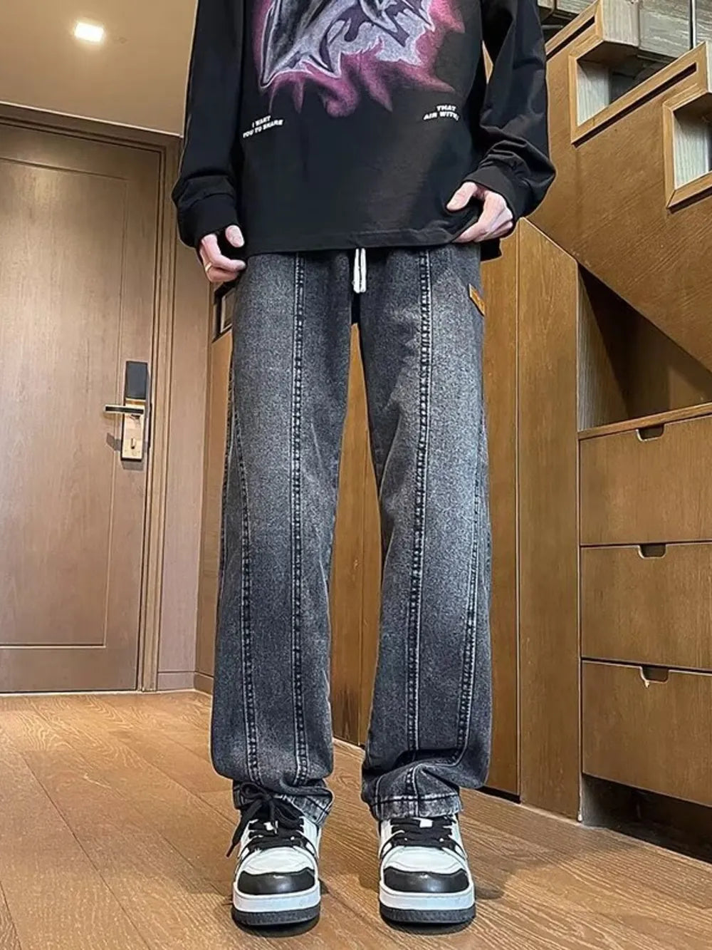 Men's dark gray vintage wash straight-leg jeans with drawstring and vertical seam detail.