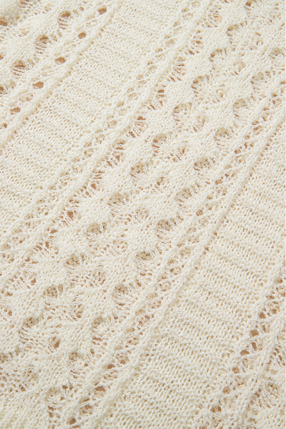 Beige openwork knit beach cover-up with intricate diamond pattern detail.