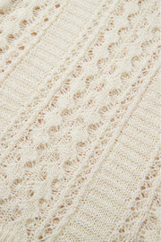 Beige openwork knit beach cover-up with intricate diamond pattern detail.