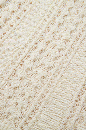 Beige openwork knit beach cover-up with intricate diamond pattern detail.