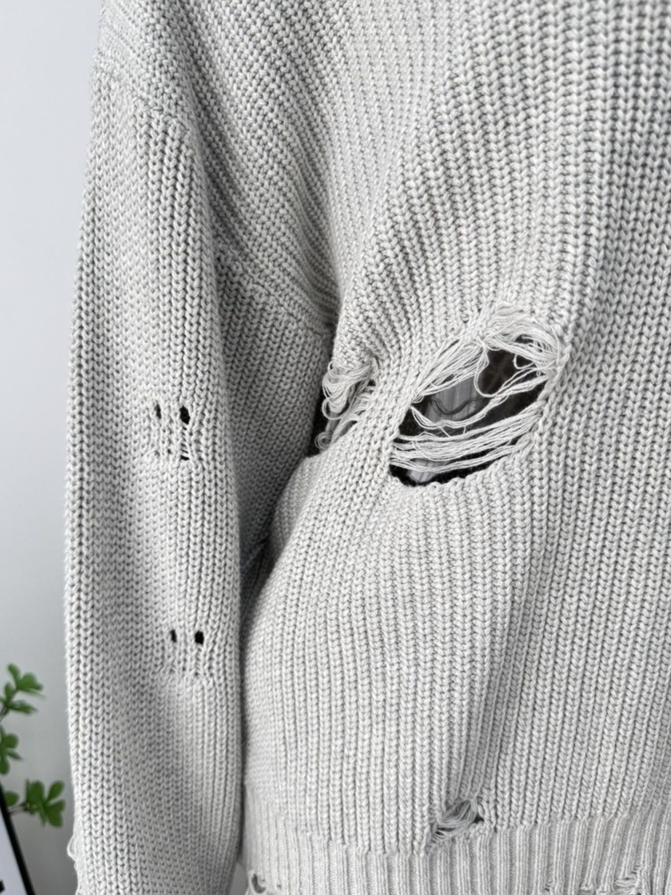 Light gray distressed cotton sweater with deconstructed details and ripped accents.