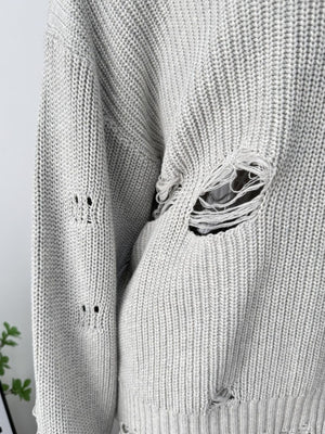 Light gray distressed cotton sweater with deconstructed details and ripped accents.