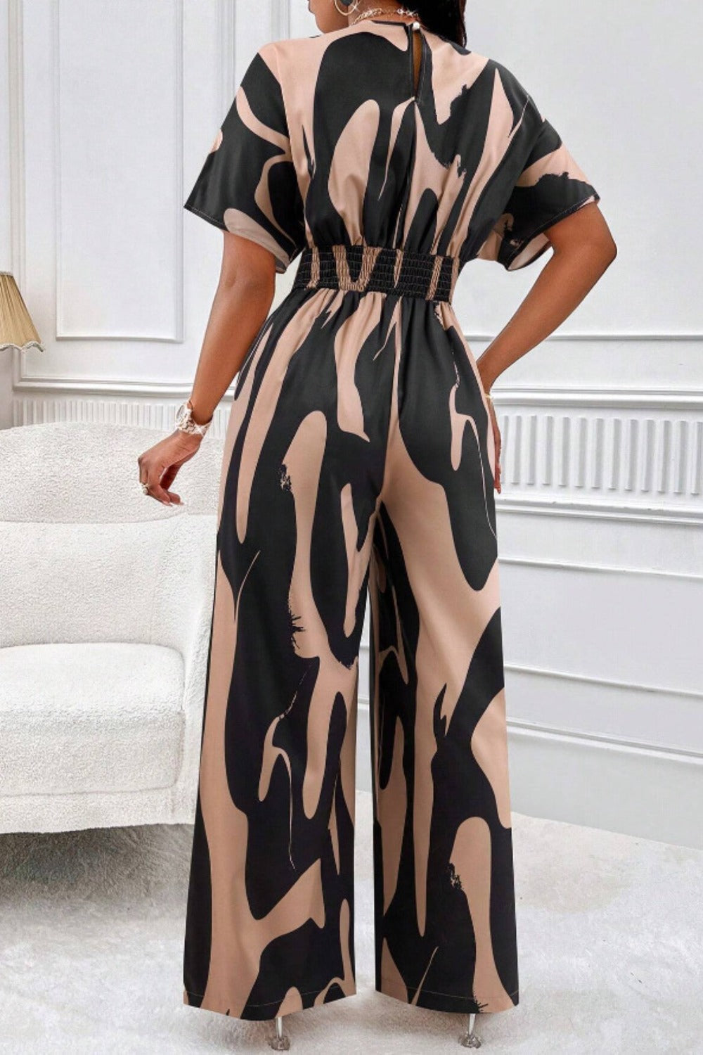 Abstract brushstroke wide-leg jumpsuit in taupe and black with short sleeves and elastic waist