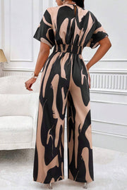 Abstract brushstroke wide-leg jumpsuit in taupe and black with short sleeves and elastic waist