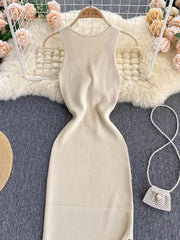 Ribbed knit midi dress in cream with a sleeveless, high neckline and bodycon fit.