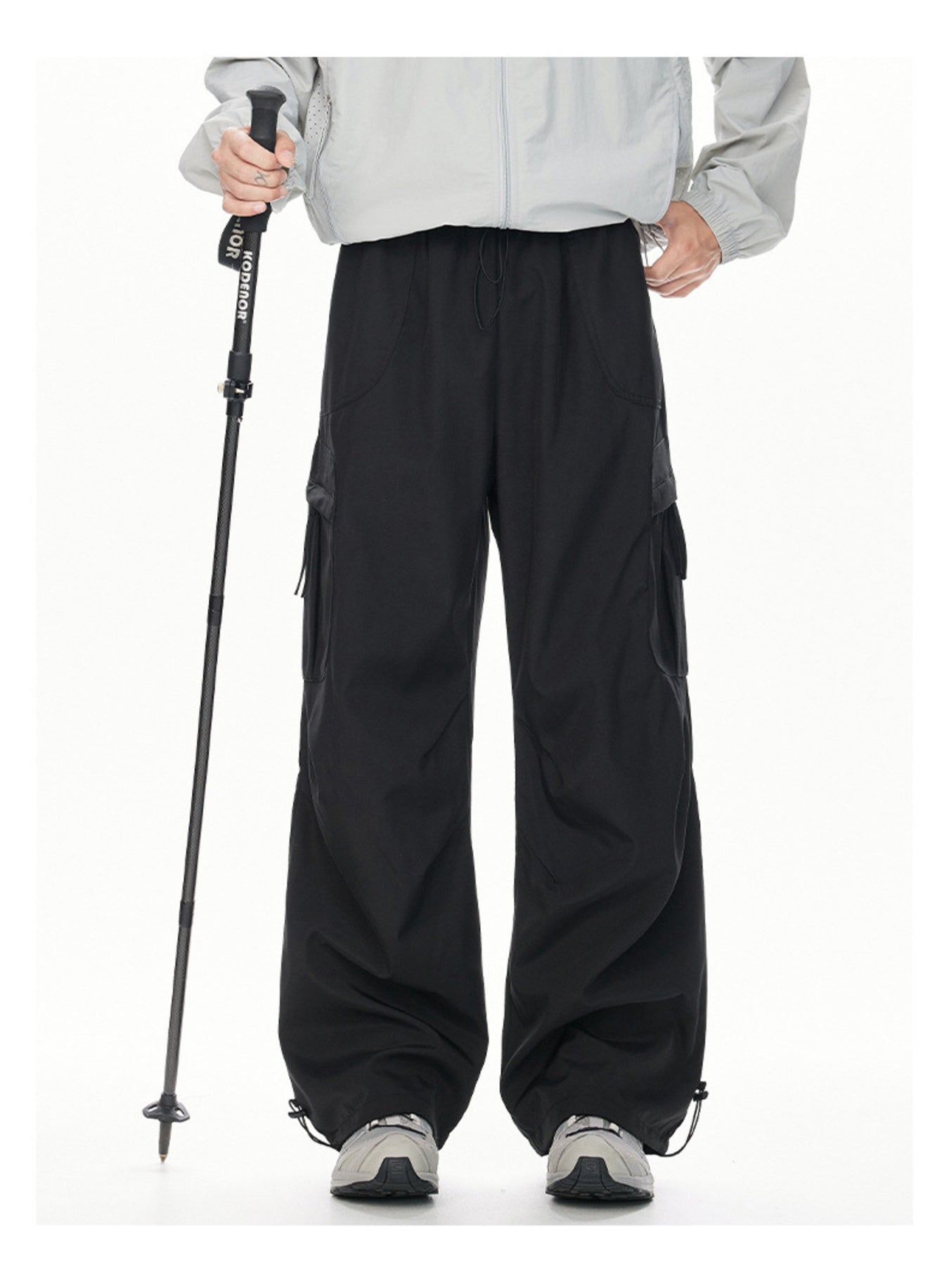 Men's black cargo sweatpants with relaxed fit and adjustable drawstring hem.