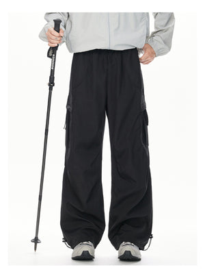 Men's black cargo sweatpants with relaxed fit and adjustable drawstring hem.