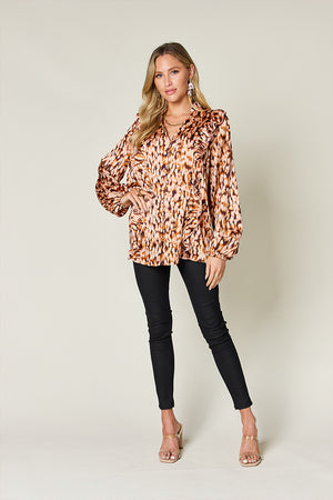 Caramel print ruffle front blouse with balloon sleeves and buttoned V-neck.