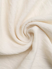 Bohemian halter maxi dress fabric detail, off-white textured linen blend.