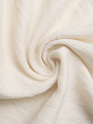 Bohemian halter maxi dress fabric detail, off-white textured linen blend.