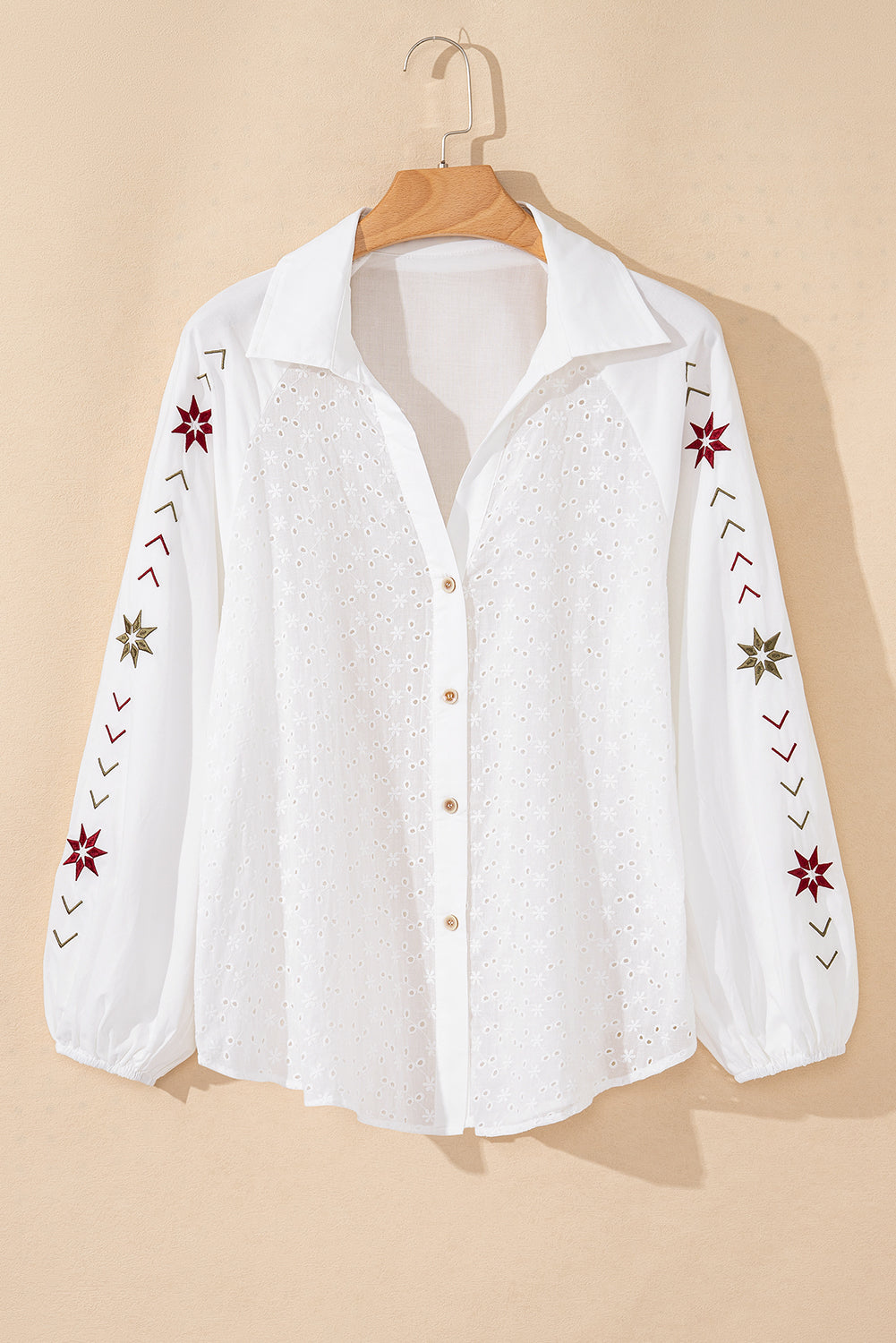 White embroidered eyelet blouse with poet sleeves and star details