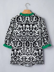 Damask print maternity blouse with green ruffled collar and cuffs, half sleeves.