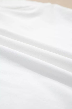 White cotton maternity t-shirt with delicate eyelet detail and flutter sleeves.