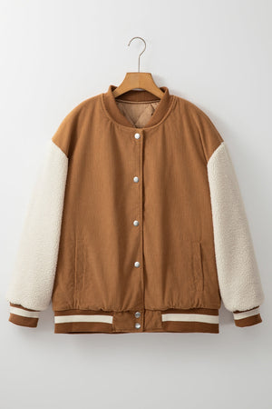 Corduroy bomber jacket in Terracotta with sherpa sleeves and striped ribbed trim.