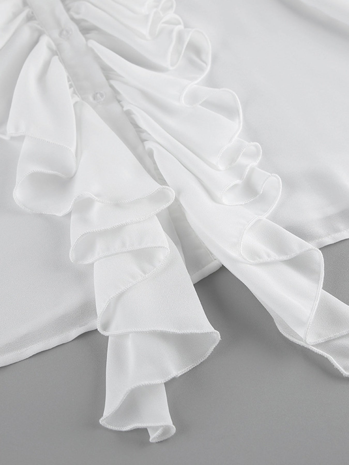 White ruffled flounce sleeve blouse with button detail