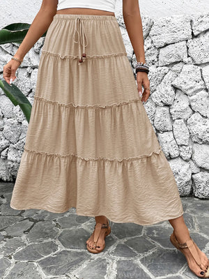 Tiered maxi skirt in tan with drawstring waist and ruffled tiers.