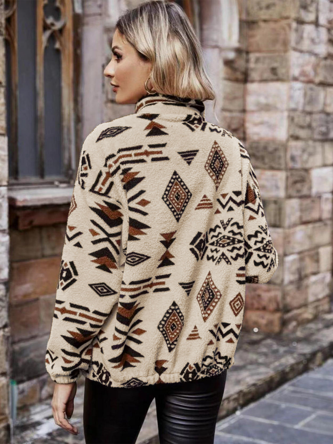Tan Aztec sherpa zip-up jacket with a mock neck and tribal print.