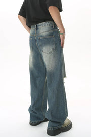 Distressed knee rip wide-leg jeans in medium wash denim with a relaxed fit.