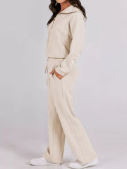 Beige half zip loungewear set with drawstring pants and a collared jacket.