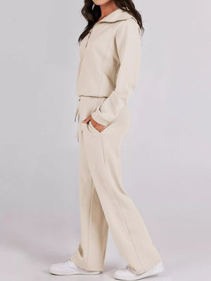 Beige half zip loungewear set with drawstring pants and a collared jacket.