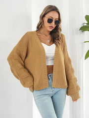 Camel knit cardigan with textured bubble sleeves and open front.