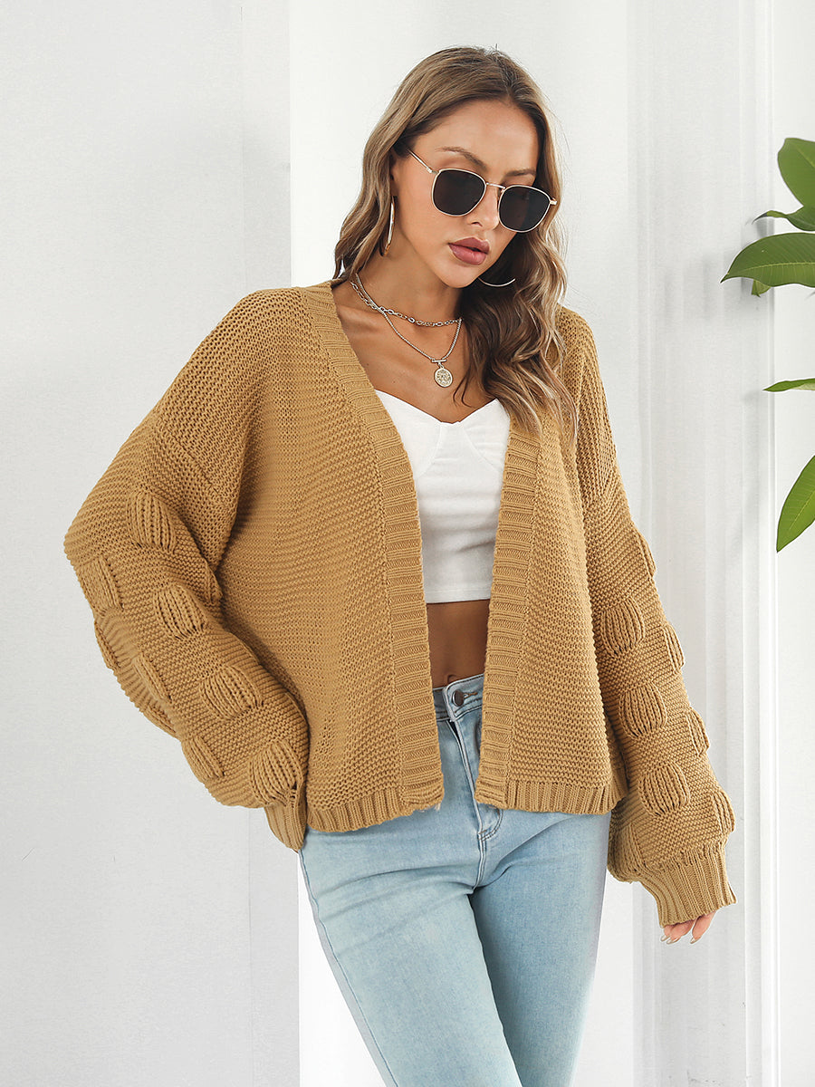 Camel knit cardigan with textured bubble sleeves and open front.