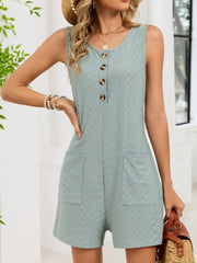 Sage buttoned sleeveless romper with textured fabric and patch pockets.