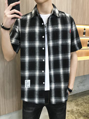 Black and white plaid oversized short sleeve button-down shirt with white t-shirt underneath.