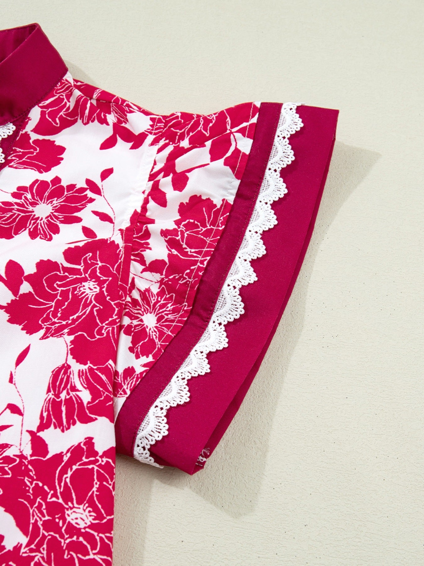 White and pink floral print polyester blouse with lace trim on sleeves and collar.