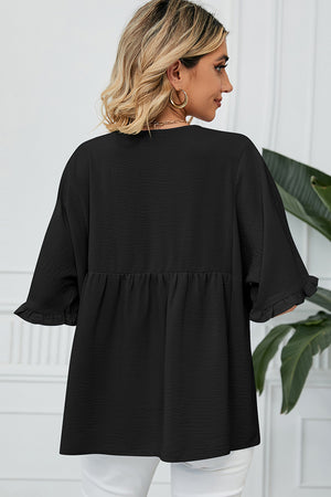 Black gathered yoke blouse with flutter sleeves and ruffled cuffs.