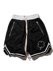 Black mesh basketball shorts with drawstring, zipper pockets, and clover detail.
