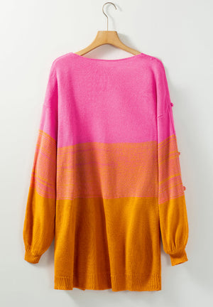 Textured colorblock acrylic cardigan in pink and orange with bobble details on the sleeve.