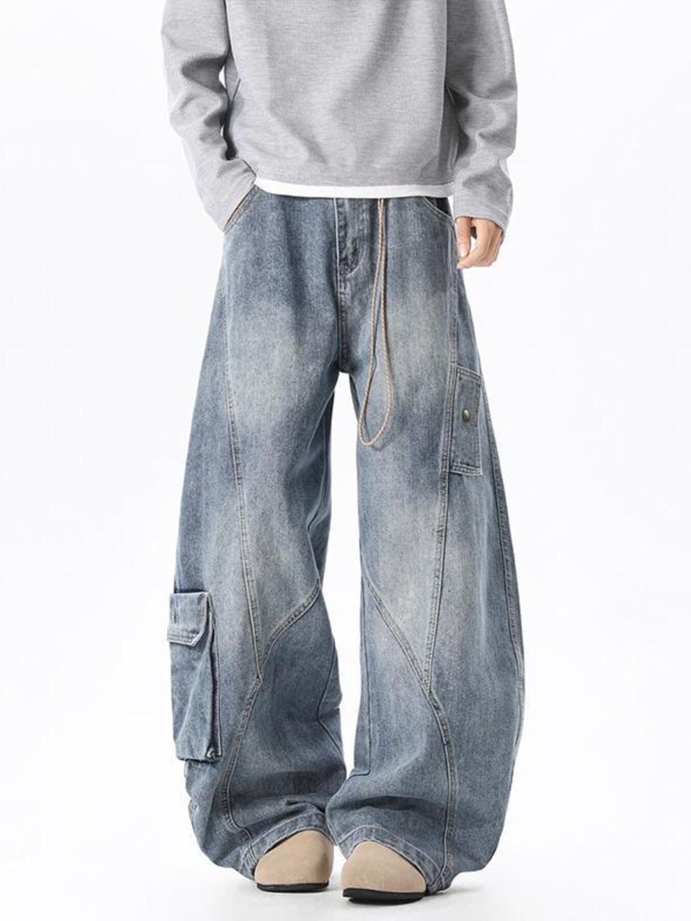 Men's blue wide leg cargo jeans with drawstring and utility pockets.