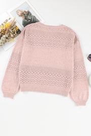 Dusty pink perforated knit V-neck pullover sweater with textured yoke and sleeves.