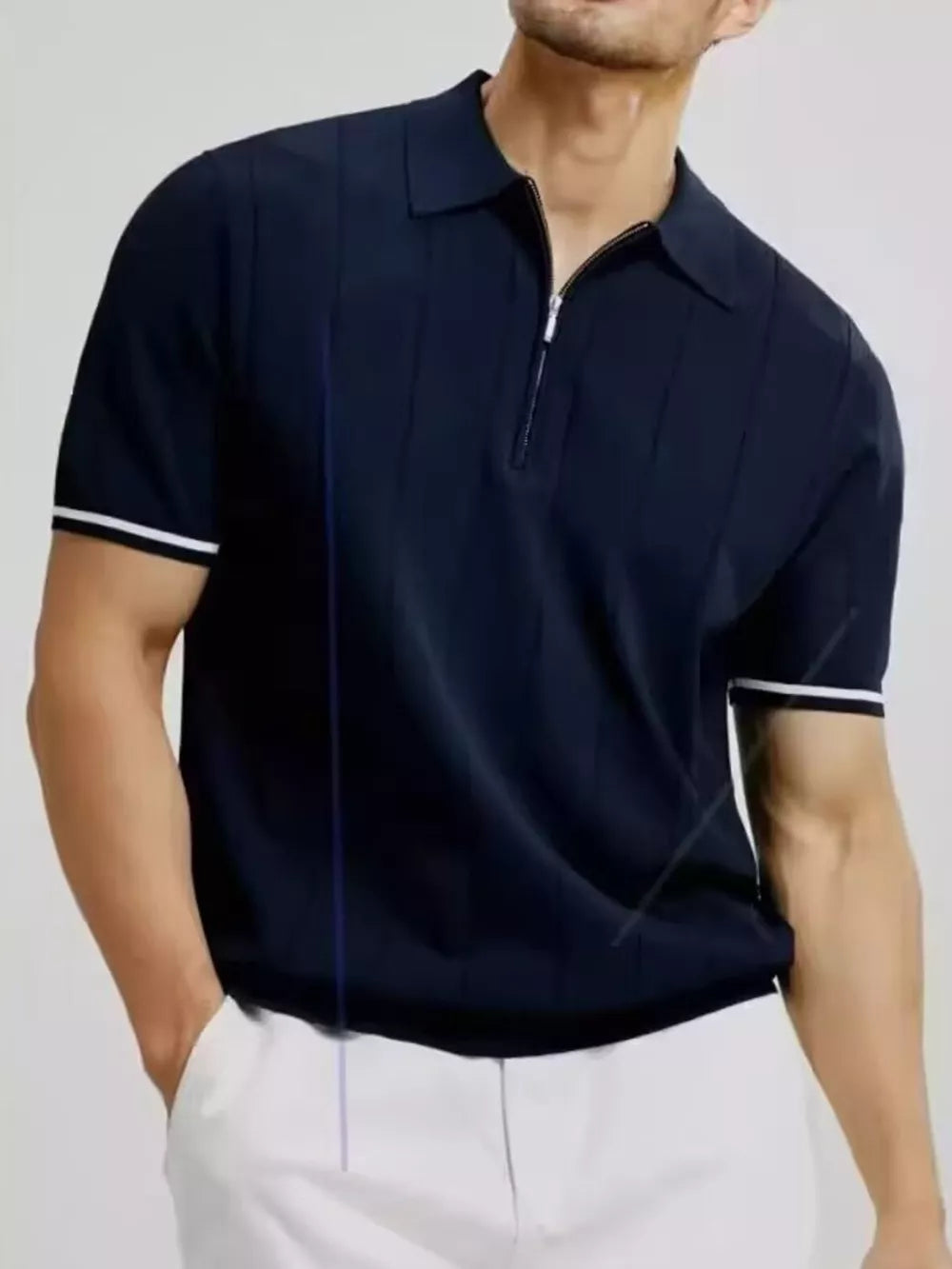 Navy blue cotton quarter-zip polo shirt with vertical ribbing and white sleeve trim.