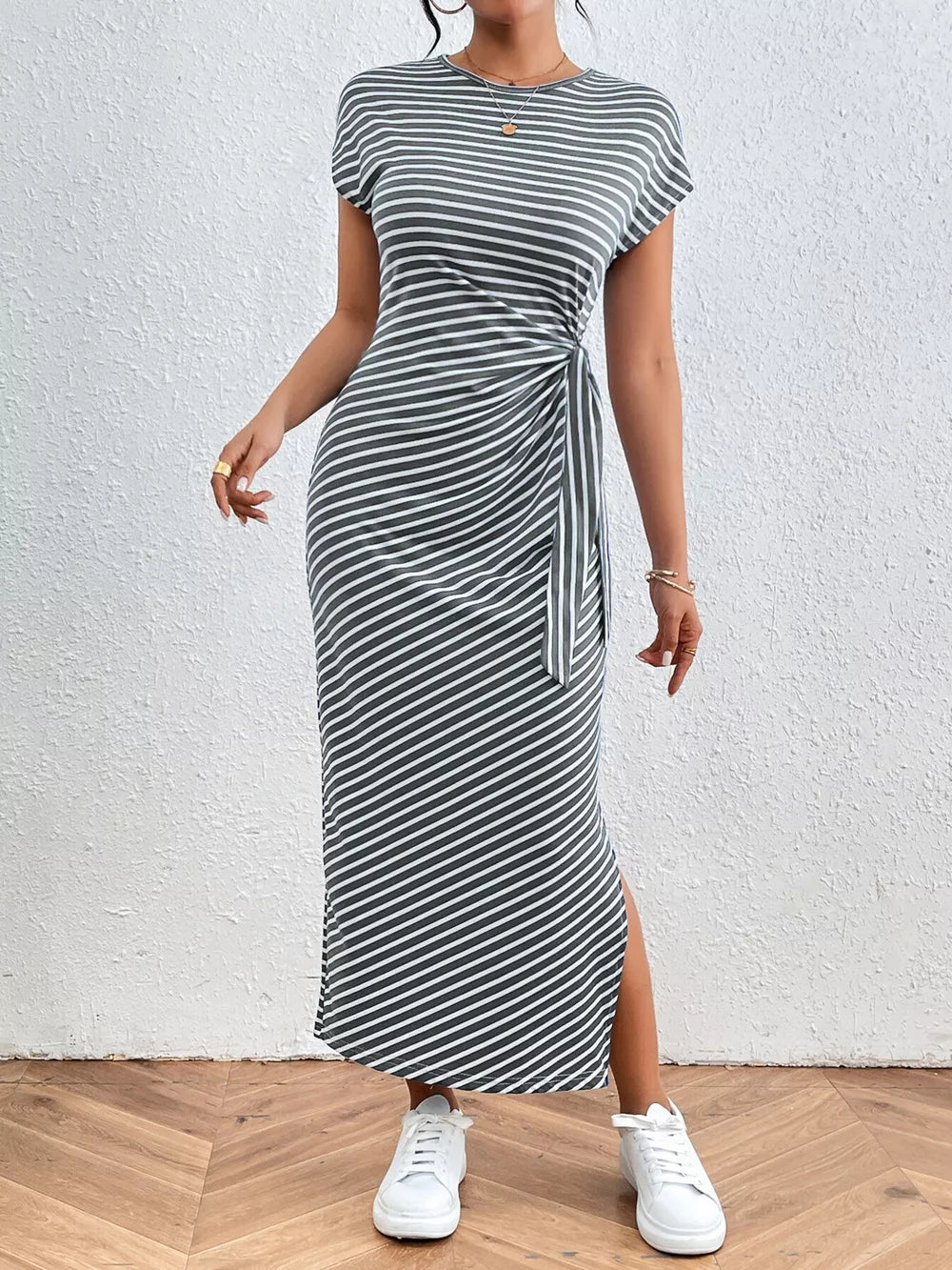 Striped midi dress with tie waist and side slit in dark gray and white.