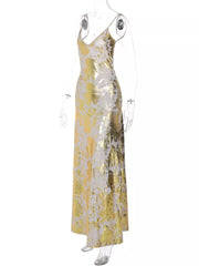 Maxi dress with abstract gold and cream pattern, V-neck, spaghetti straps, and backless detail.