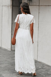 White lace midi dress with short sleeves, V-neck, and scalloped hem.