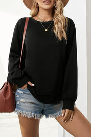 Black crewneck sweatshirt with asymmetric hemline and cuffed sleeves