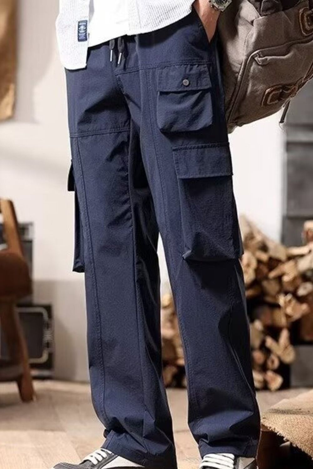 Navy blue cargo pants with drawstring waist and multiple flap pockets.