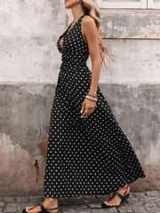 Black polka dot maxi dress with halter neck and cinched waist