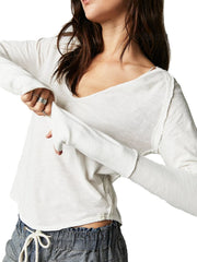 White distressed slouchy long sleeve tee with plunge neckline and raw edges.