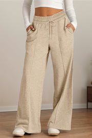 Seamed palazzo lounge trousers in tan with drawstring waist and pockets.
