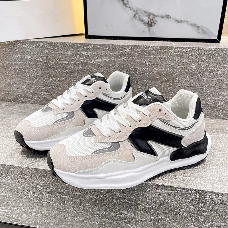 Panelled retro runner sneakers in beige and black with white mesh and suede accents.