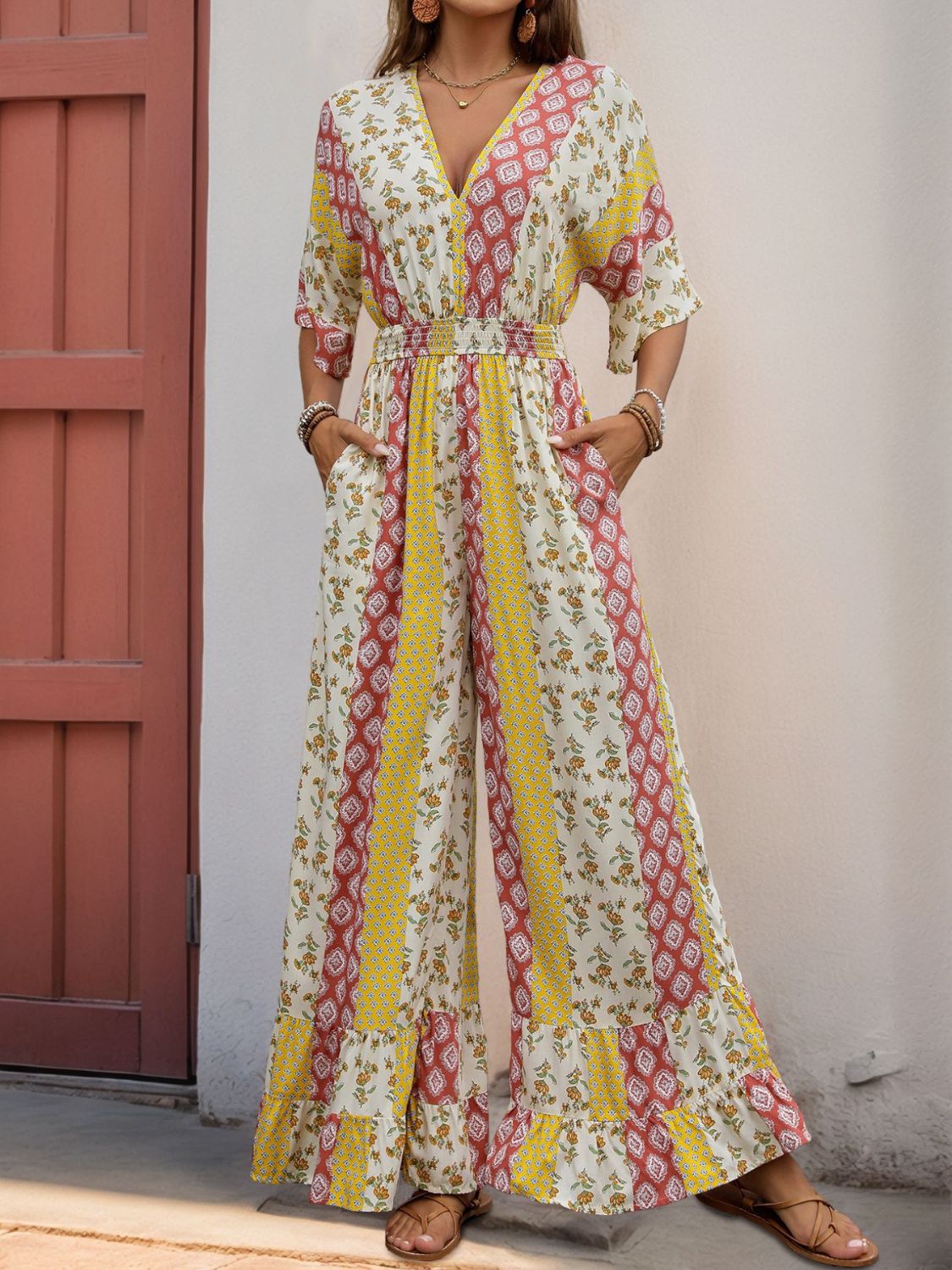 Bohemian print palazzo jumpsuit with V-neck, smocked waist, and wide legs in multicolor.