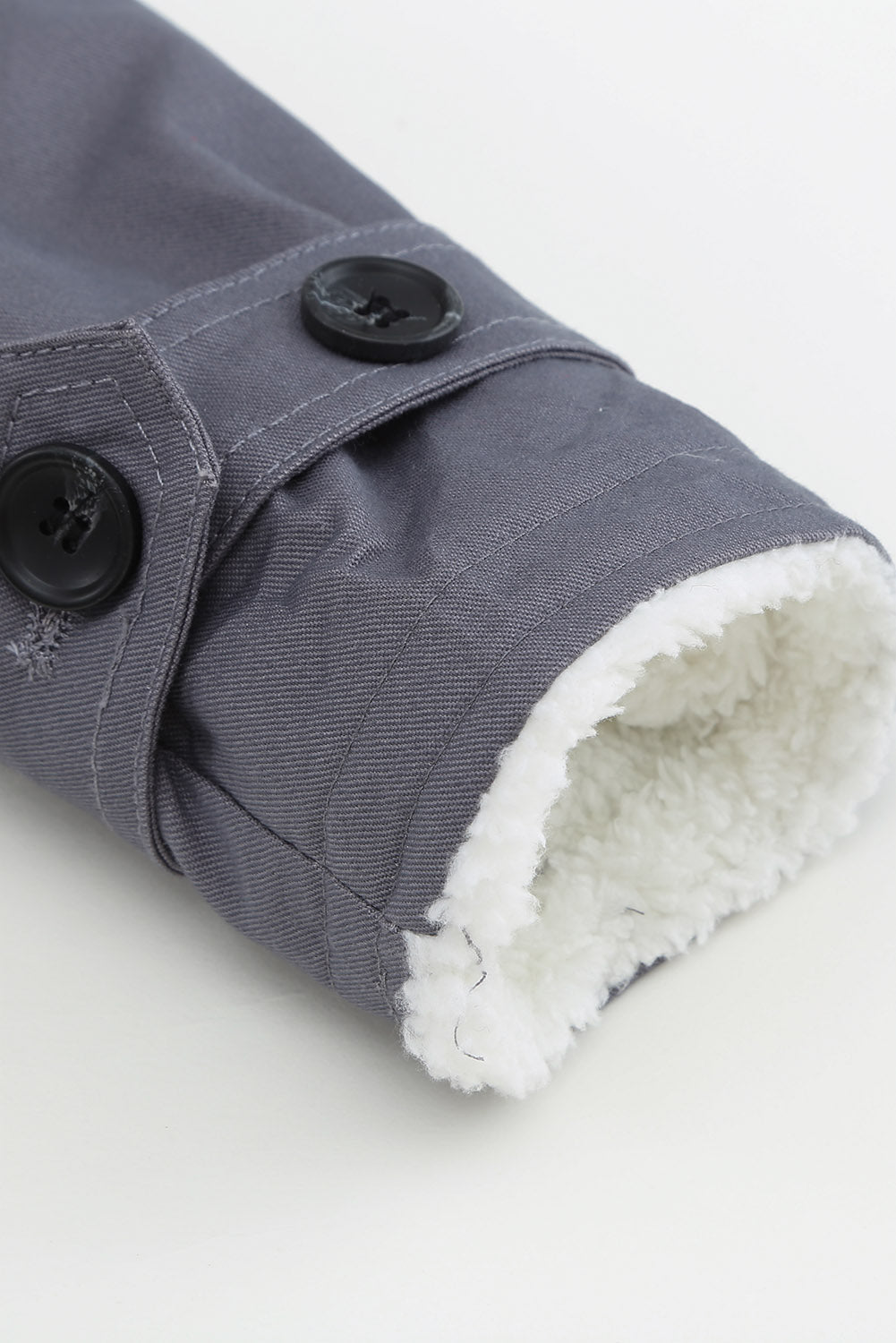 Dark gray canvas button-down jacket with sherpa lining detail on sleeve cuff and black buttons.
