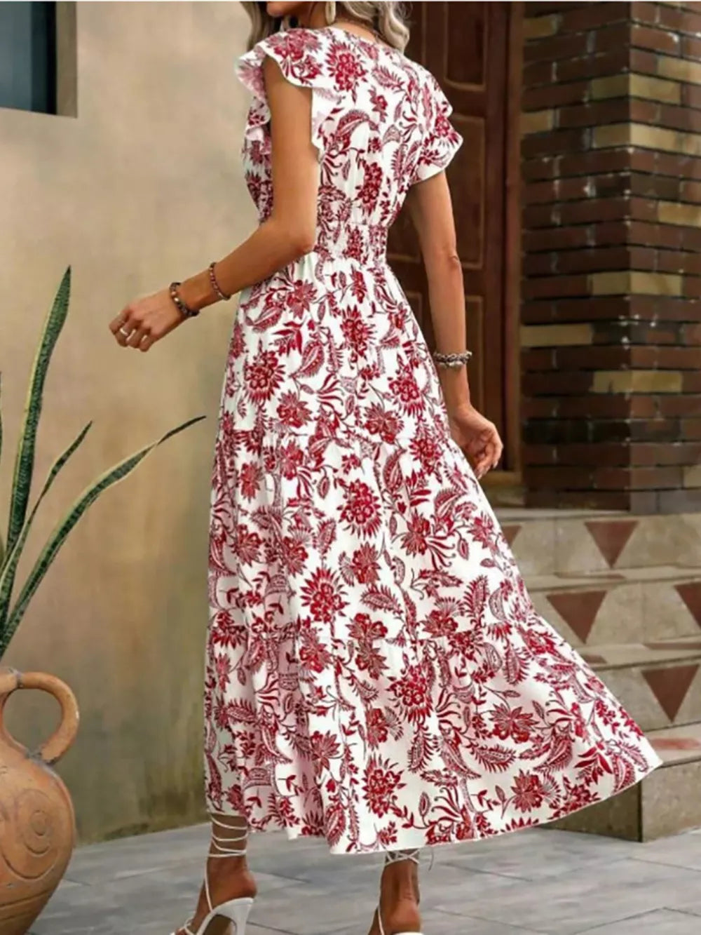 Botanical ruffle sleeve midi dress in white with red floral print, polyester, with smocked waist and tiered skirt.
