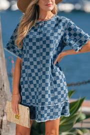 Denim mini dress with checkered pattern, frayed hems, and short sleeves.